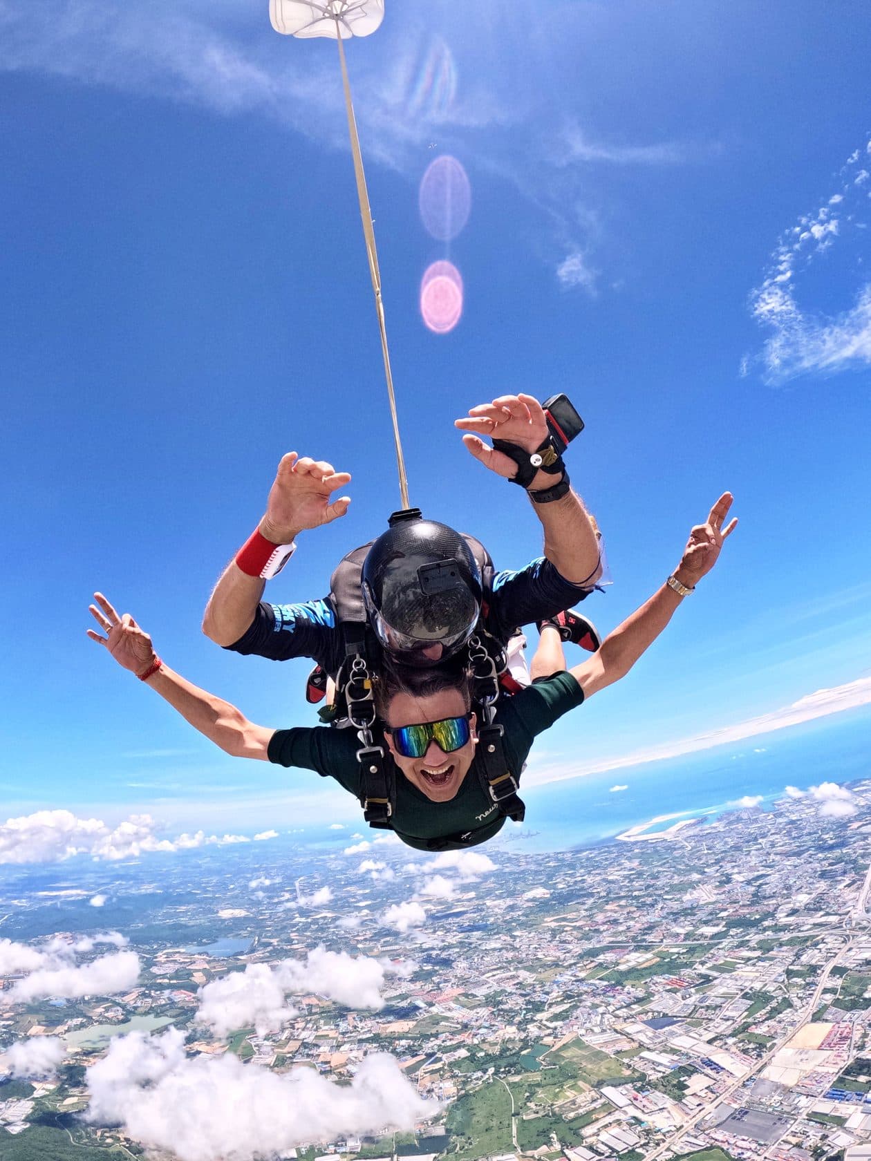 Tandem pair in freefall with the Pattaya coastline below them