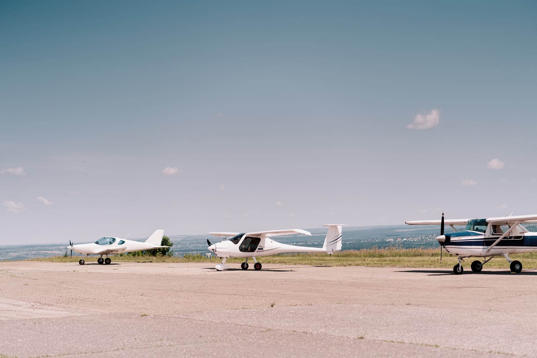 Small propeller aircraft parked on a grass airfield